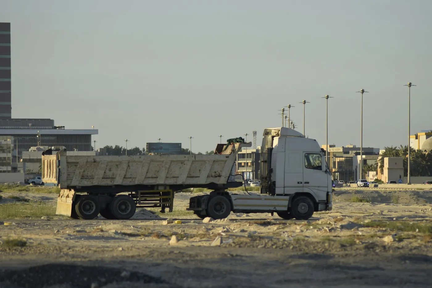 Truck with a tipper body parked on a site.